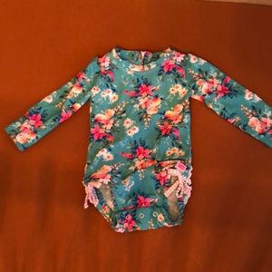 Rufflebutts girls rashguard swimsuit.